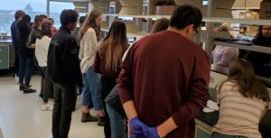 Children stand around lab bench at CHRIM.