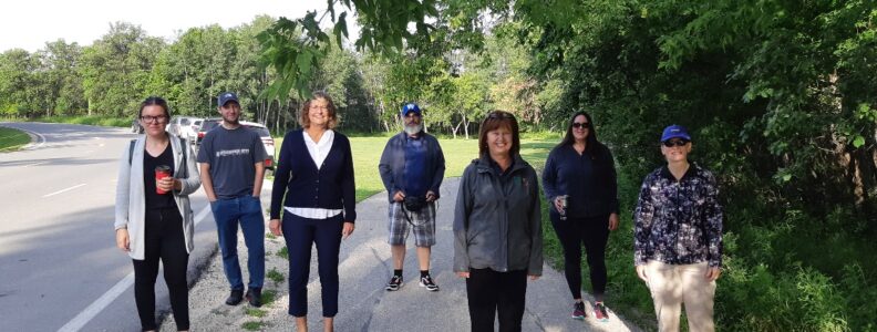Members of CHRIM standing outside at a park smiling.
