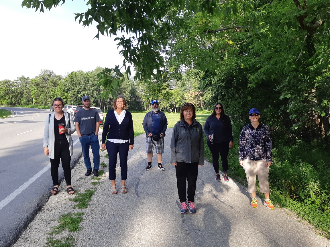 Members of CHRIM standing outside at a park smiling.