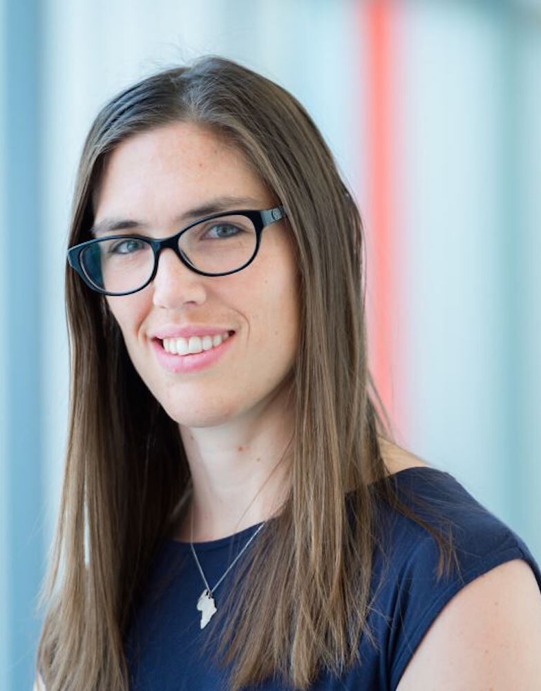Portrait of Dr. Drögemöller in black glasses, a blue top, and a necklace.