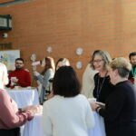 CHRIM members mingling at festive get together. Tannis Erickson is in focus laughing.