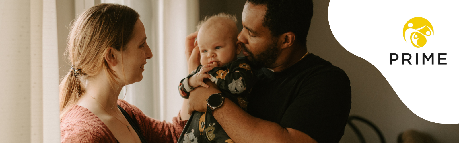 Mother and father holding a baby.