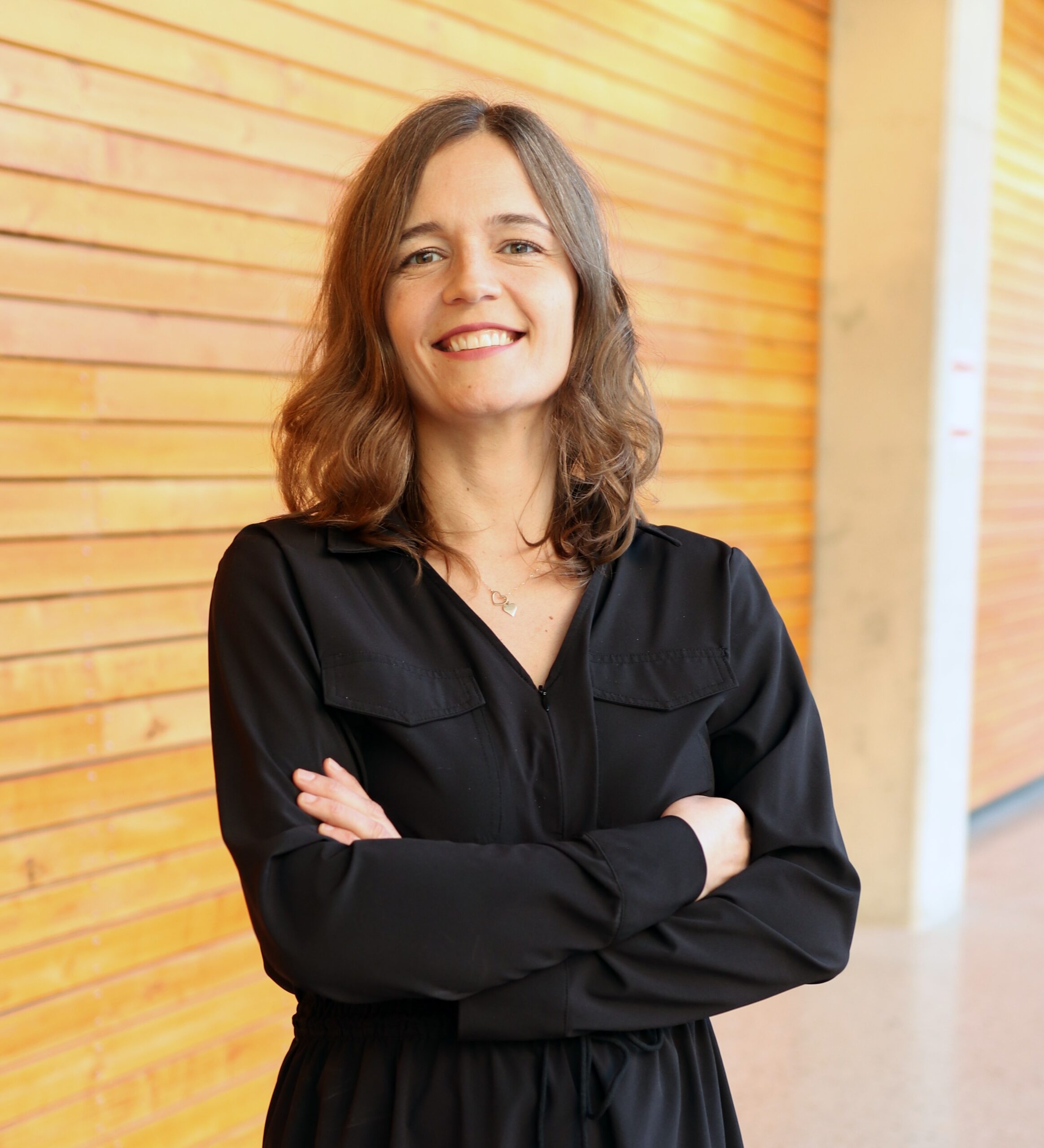 Dr. Anna M Chudyk standing with arms crossed.